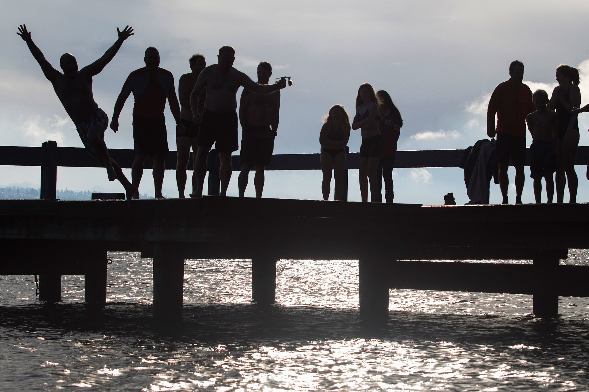 Polar Bear Plunge swimmers jump off the dock at Clarke Beach on New Year’s Day. It was the 50th anniversary of the event, started by Nile Clarke. Matt Brashears/Special to the Reporte