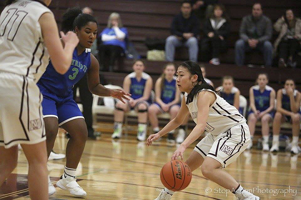 Photo courtesy of Don Borin/Stop Action Photography                                Mercer Island senior point guard Kailee Yan, right, makes a move against Liberty defender Jasmine Baker, left, in a matchup between KingCo squads on Jan. 4 in Mercer Island. The Islanders defeated the Patriots 64-29.