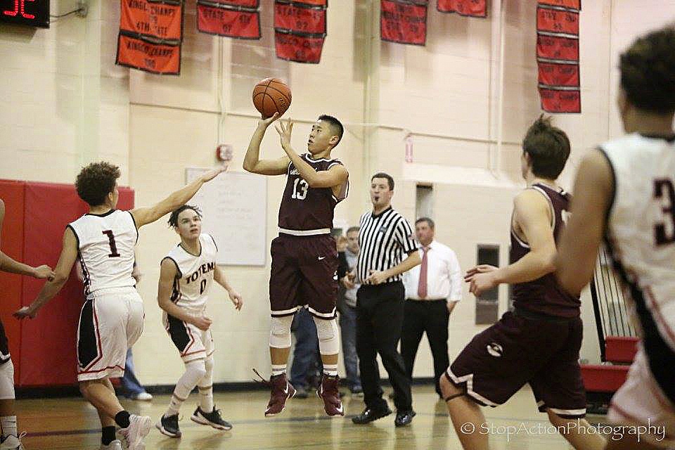 Photo courtesy of Don Borin/Stop Action Photography                                Mercer Island junior guard William Lee, center, puts up a short jump shot against the Sammamish Totems. The Islanders defeated the Totems 75-48 on Jan. 10 at Sammamish High School in Bellevue.
