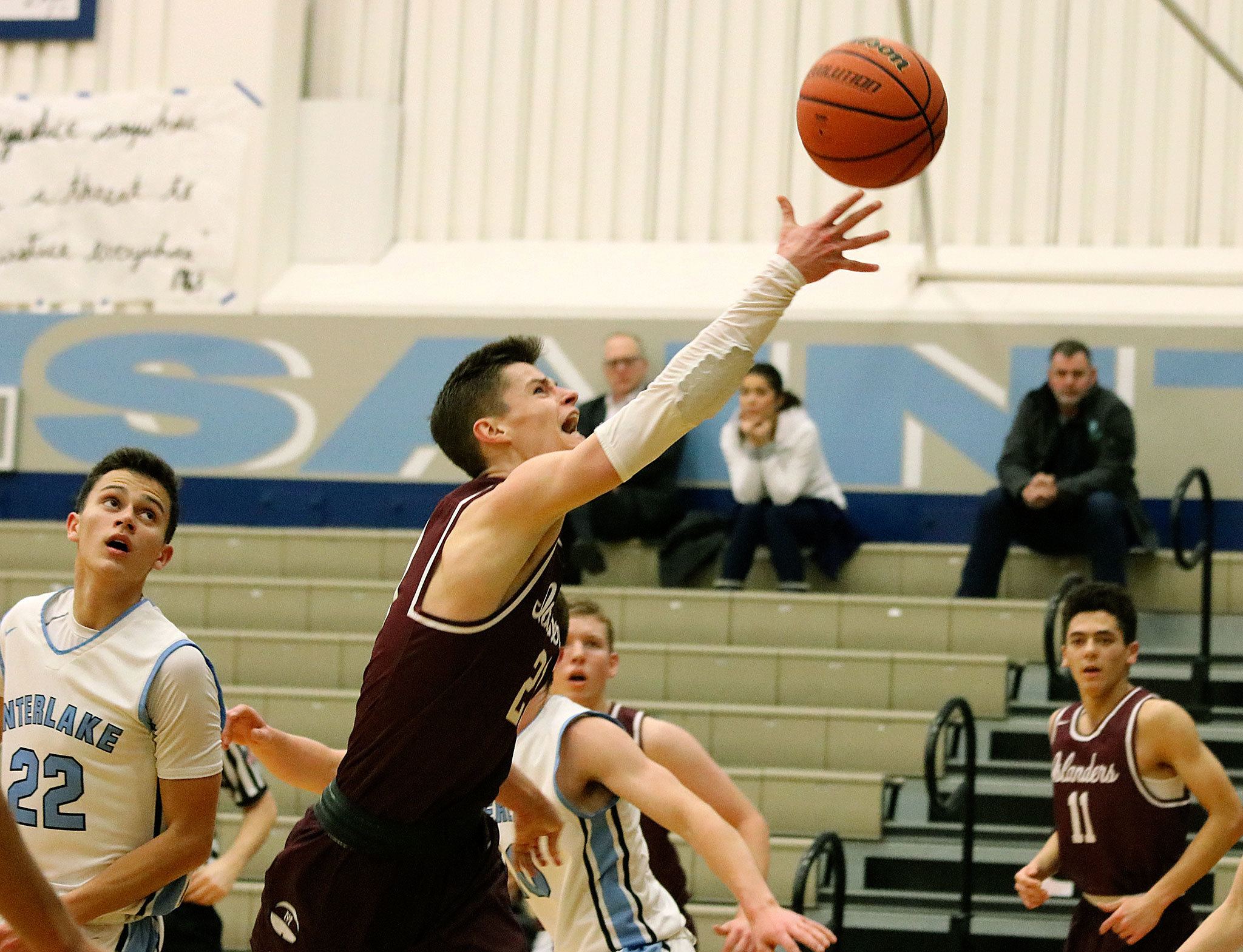 Mercer Island’s Shain Scott goes in for the layup Tuesday night against Interlake. The Islanders beat the Saints 70-28 (Joe Livarchik/staff photo).