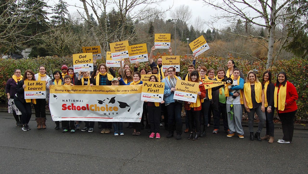 Students and staff at Yellow Wood Academy, a nonprofit private school in Mercer Island, hold up signs and wear scarves to celebrate School Choice Week on Jan. 25. Katie Metzger/staff photo