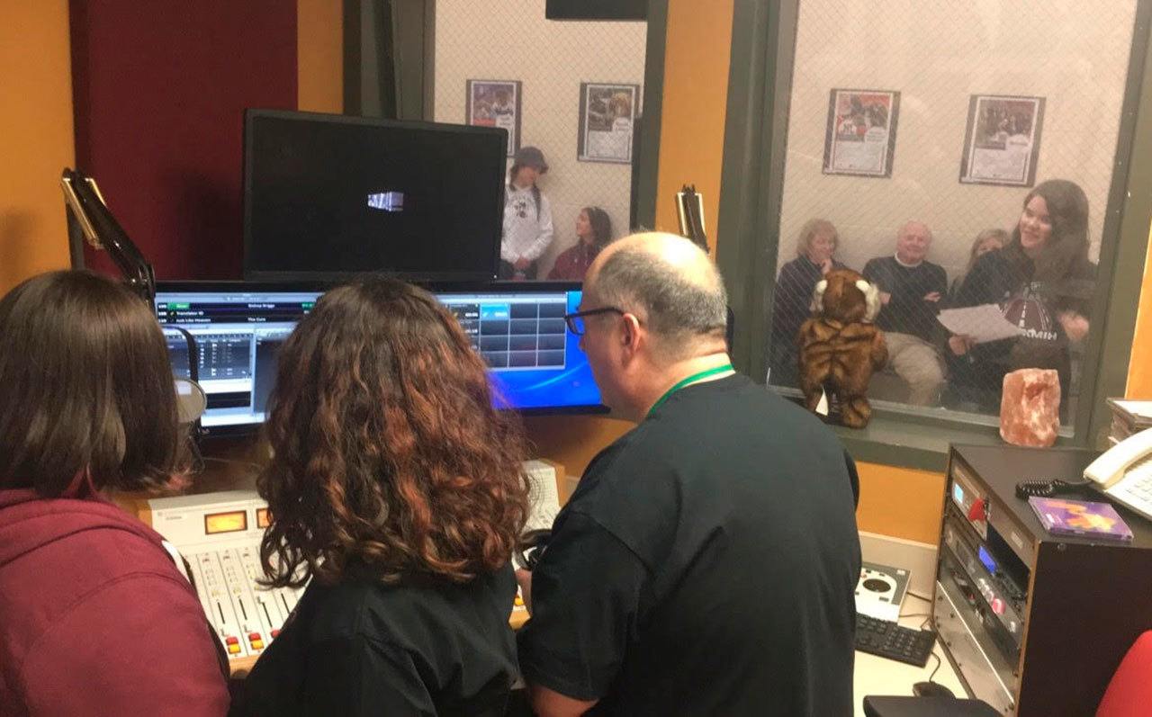 Broadcast media instructor Joe Bryant and program director Leah Raissis select songs to play in the first hour broadcasting as 88.9 The Bridge. Katie Metzger/staff photo