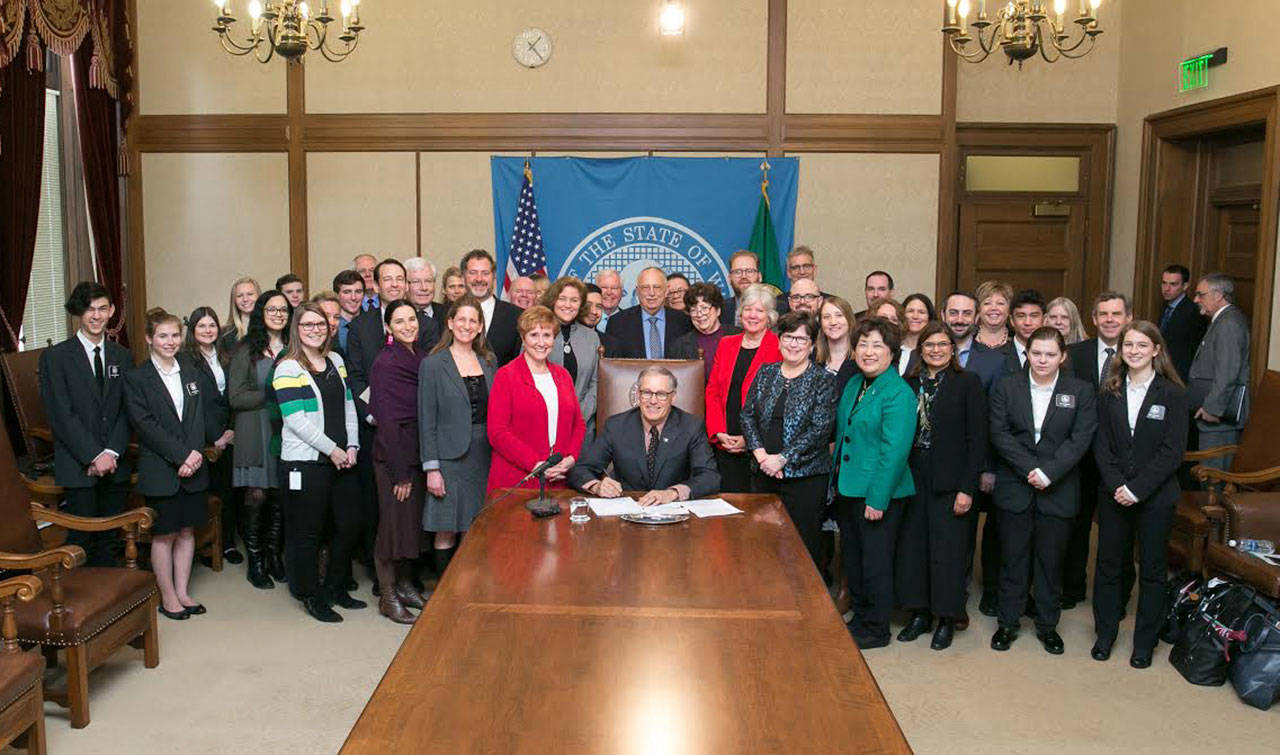 Gov. Jay Inslee signs Senate Bill No. 5023, relating to delaying implementation of revisions to the school levy lid and sponsored by Lisa Wellman (D-Mercer Island). Photos courtesy of Aaron Barna/Washington State Legislature