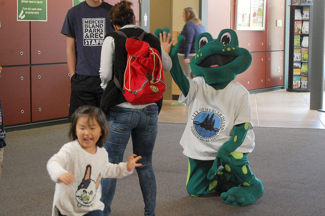Leap, the sustainability fair’s frog mascot, meets Islanders at the Community and Event Center. Katie Metzger/file photo