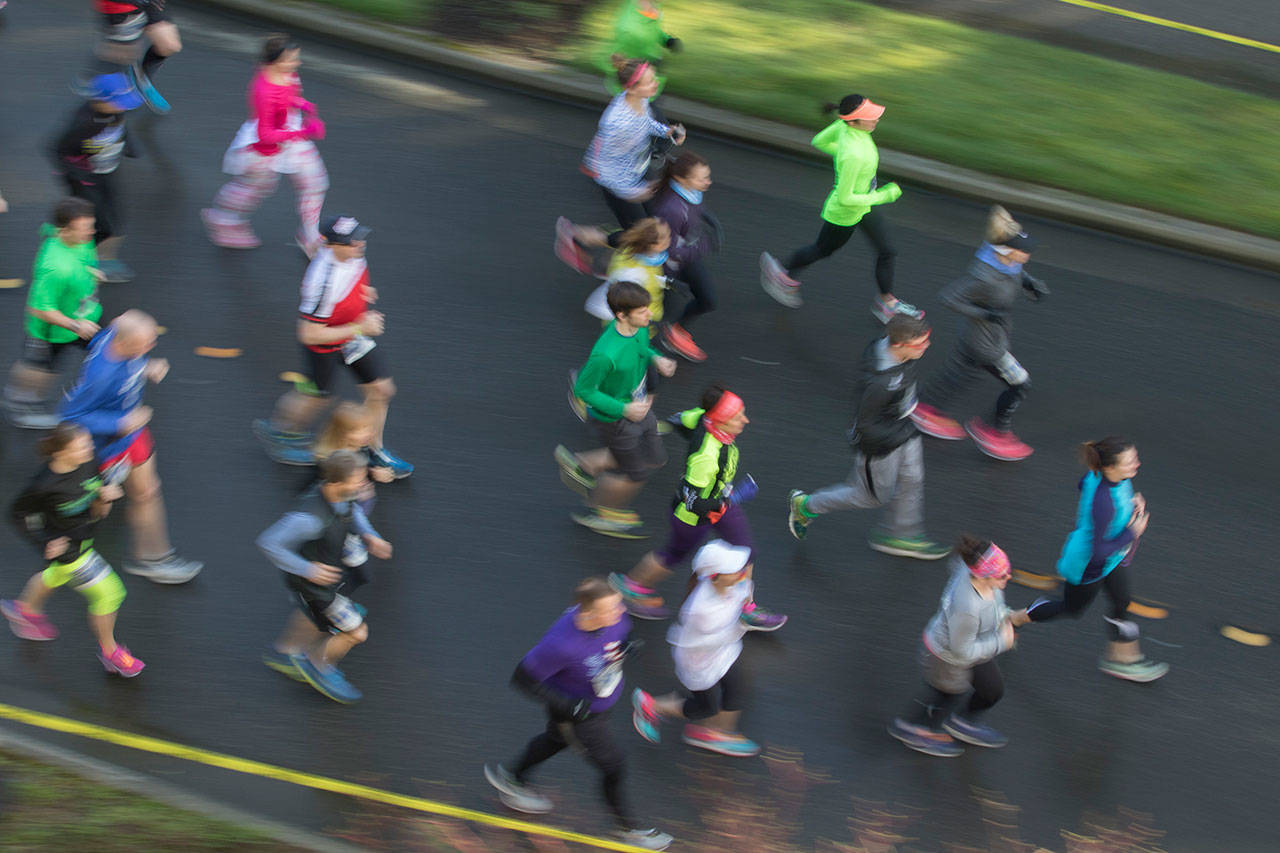 Runners head down North Mercer Way off Luther Burbank Park in the first mile of the Half Marathon Sunday. Matt Brashears/Special to the Reporter