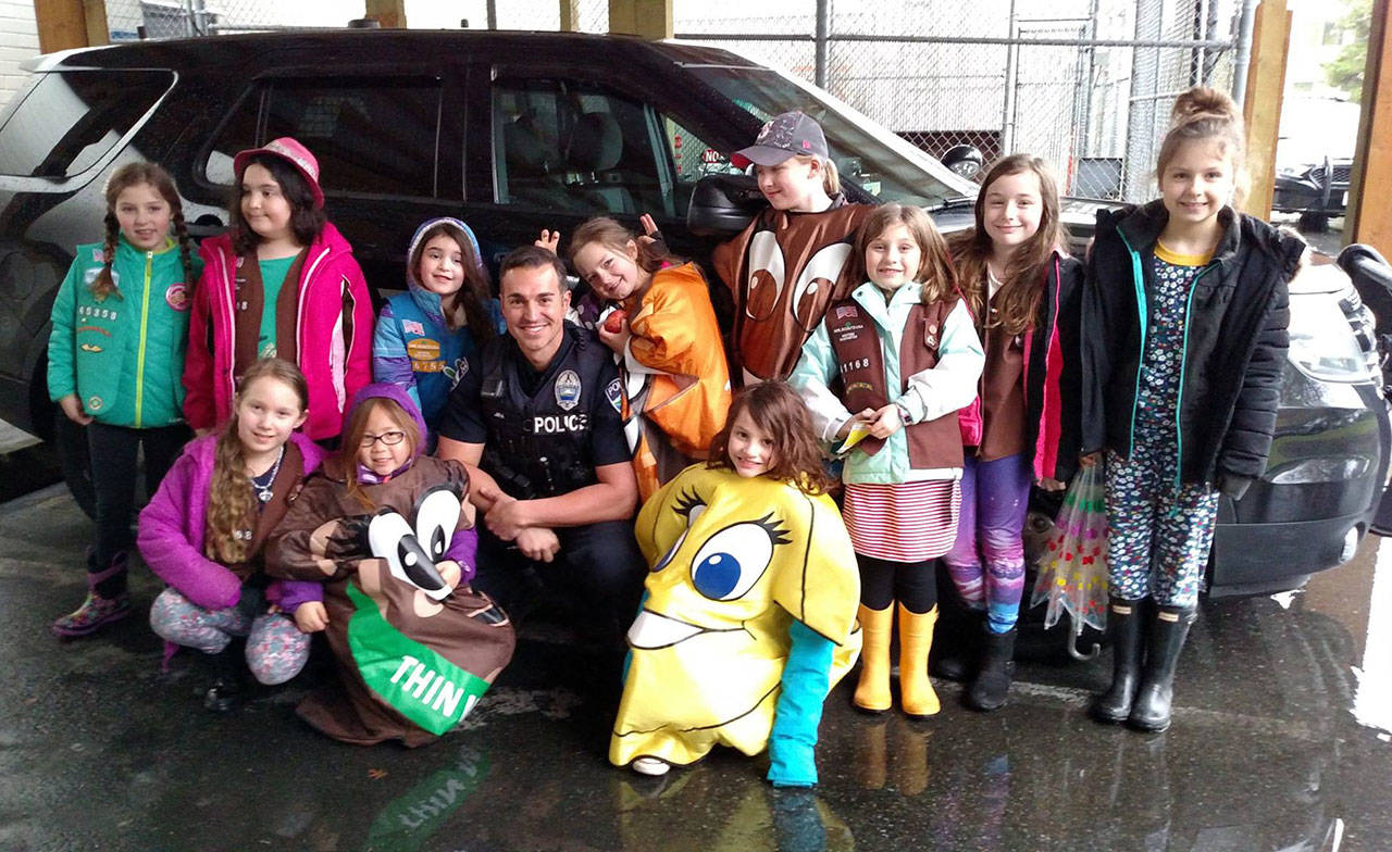 Girl Scouts pose with an MIPD officer and patrol car. Photo courtesy of MIPD