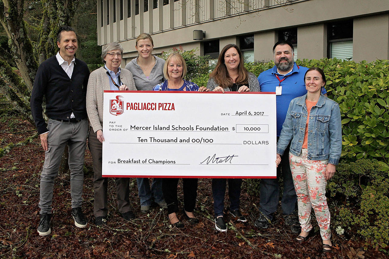 Matt Galvin presents a check to the Schools Foundation on behalf of Pagliacci Pizza. Photo courtesy of Michelle Galvin