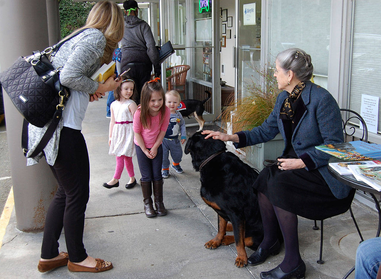 Valerie Hay (in pink), with her siblings Lydia and Connor and mom Ashley, meets Carl of the popular “Good Dog, Carl” book series and its author, Alexandra Day, at a book signing event on April 14 at MercyVet in Mercer Island. Katie Metzger/staff photo