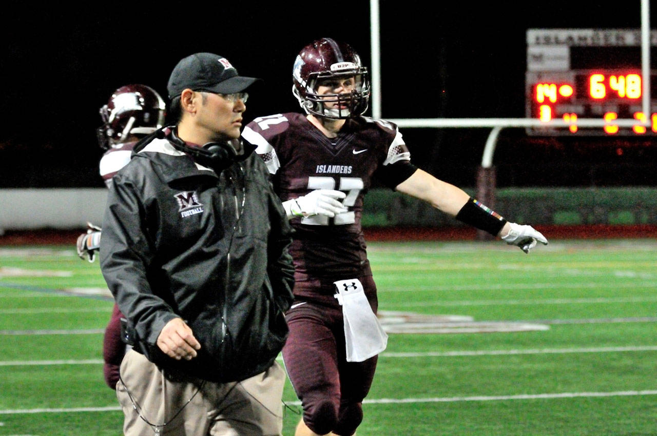 Brett Ogata, left, roams the Mercer Island sidelines during a game against Lake Washington in the fall of 2013. Last Friday, Ogata was named the new football coach at Kentridge High School (Carrie Bell/file photo).