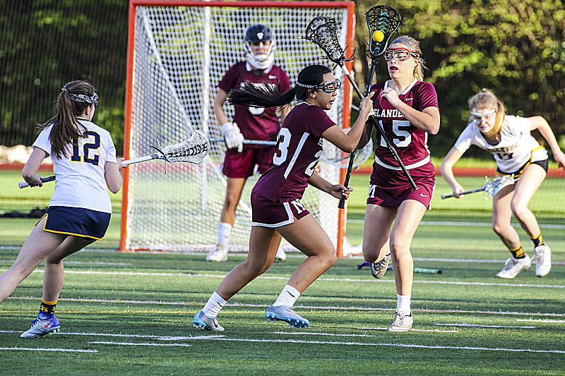 Photo courtesy of Rick Edelman/Rick Edelman Photography                                Mercer Island Islanders girls lacrosse players Ellie Sulia, center, and Julia Nordstrom, right, are pictured in a contest against the Bellevue Wolverines. Mercer Island cruised to a 17-3 victory against the Bellevue Wolverines on April 20.