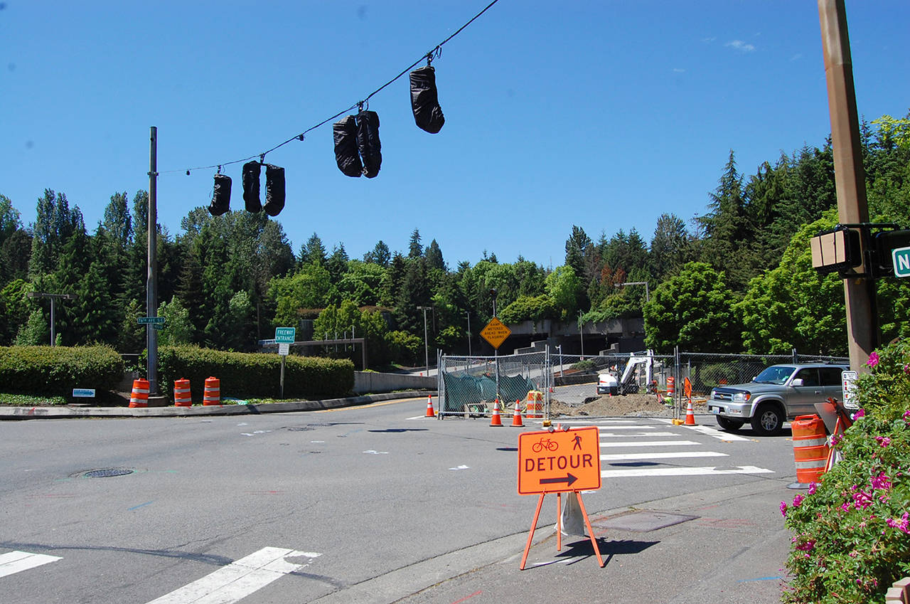 A driver navigates the intersection at 76th Avenue Southeast and North Mercer Way, which is under construction as part of Sound Transit&rsquo;s temporary traffic improvements, meant to mitigate impacts once the Interstate 90 center lanes close on June 3. Katie Metzger/staff photo