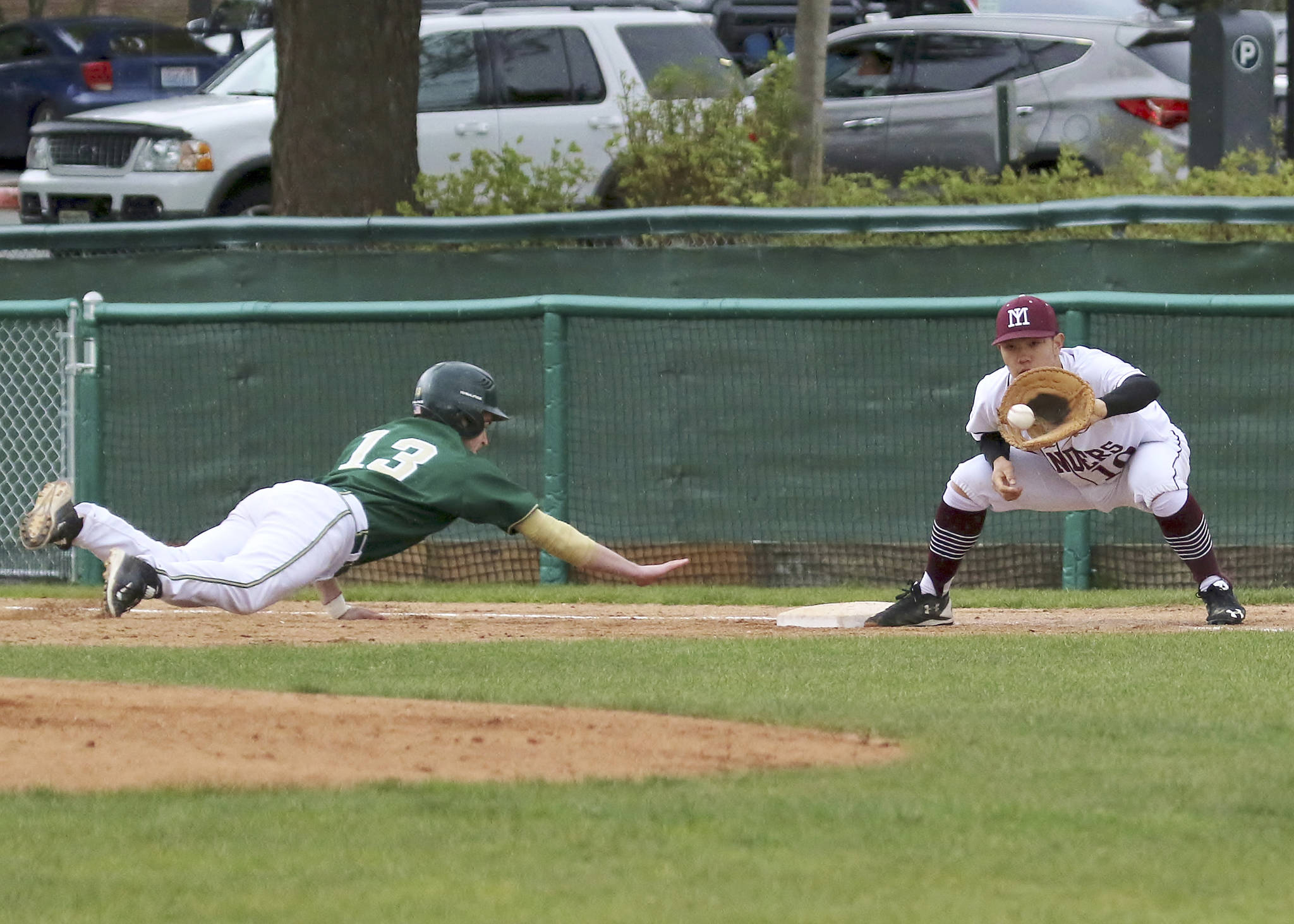 Photo courtesy of Jim Nicholson                                Mercer Island first baseman Justin Ho prepares to tag out Redmond base-runner Cameron Allen-Shipman in a contest on April 26 at Bellevue College. The Islanders have compiled an impressive 18-2 overall record thus far this season. The Islanders will compete in the first round of the Class 3A state tournament at 1 p.m. on May 20 at Bannerwood Park in Bellevue.