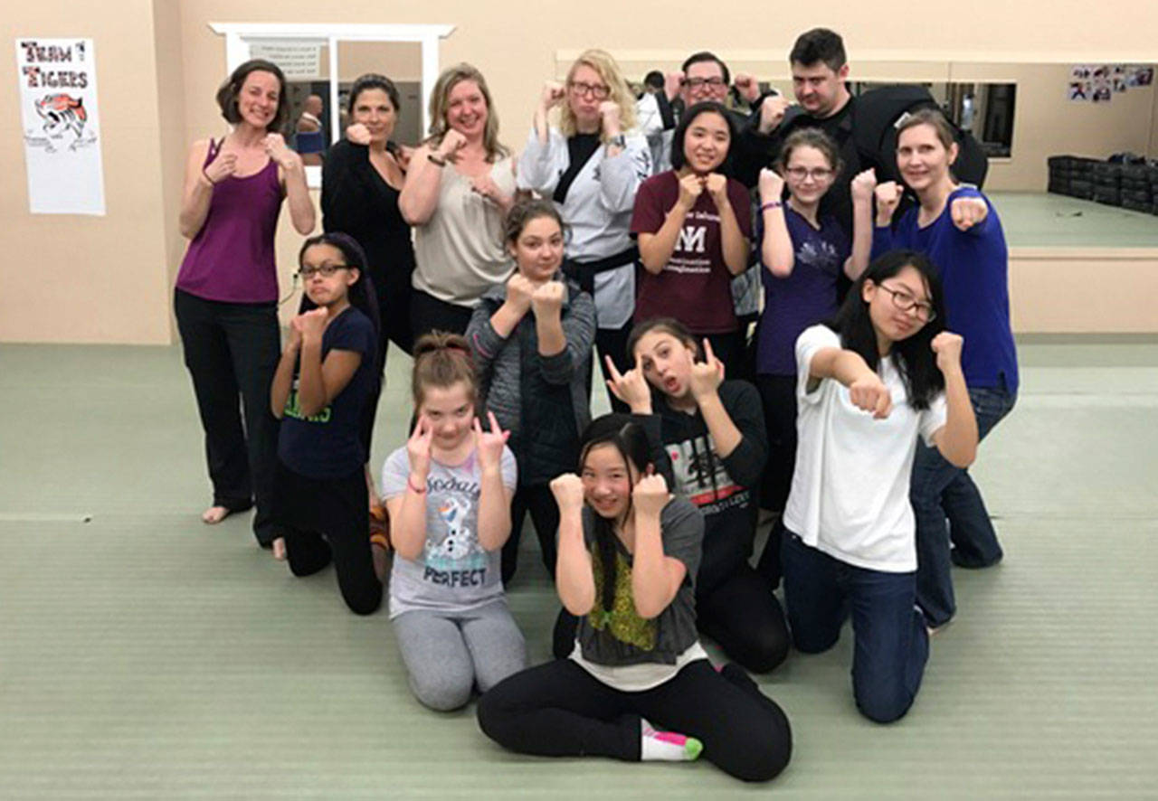 Members of Cadette GS Troop 44297 learned how to protect themselves in threatening situations from a police officer and martial arts instructors. Photo courtesy of Terese Broccoli