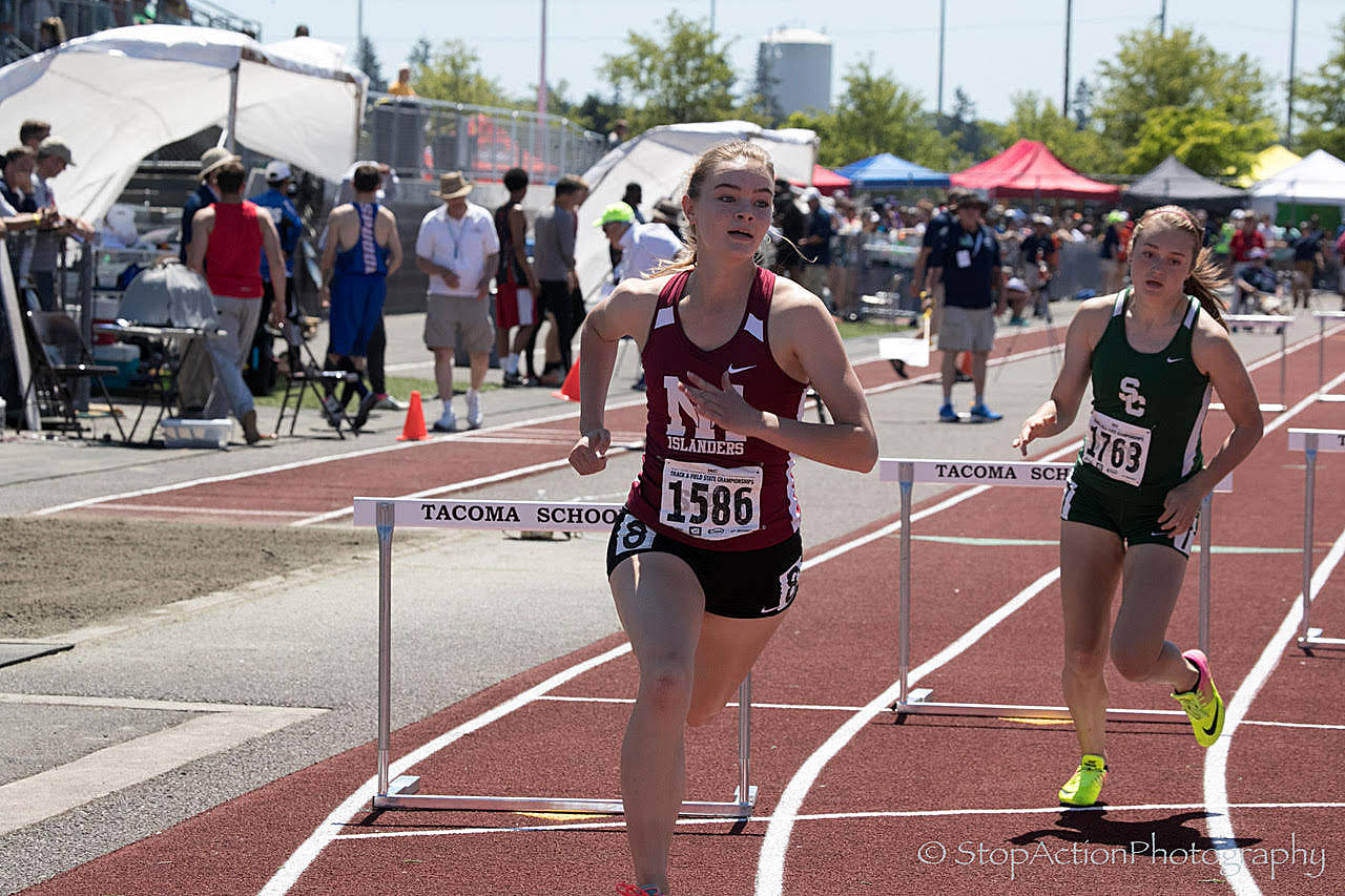 Photo courtesy of Don Borin/Stop Action Photography                                Mercer Island track athlete Kendra Watson, left, rounds the corner while competing in the 300-meter hurdles at the Class 3A state track meet on May 27 at Mount Tahoma High School in Tacoma.