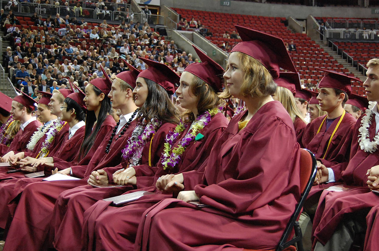 Mercer Island High School seniors listen to a speech from teacher Chris Twombley at graduation on June 8. Twombley “hypnotized” the crowd and told them to hold hands. He also told them to suspend their disbelief, be receptive to new ideas and “live curiously.” Katie Metzger/staff photos