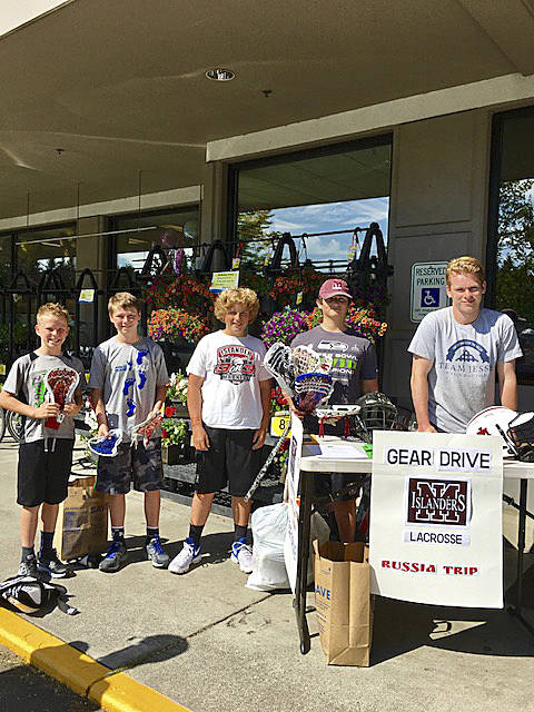 Photo courtesy of Laura Jantos                                Mercer Island lacrosse players Max Jantos and Will St. Mary team up with a few Mercer Island Lacrosse Club youth players during a gear drive at QFC on Mercer Island on July 15. The Islanders boys lacrosse team will visit Russia from From July 27 through Aug. 8.