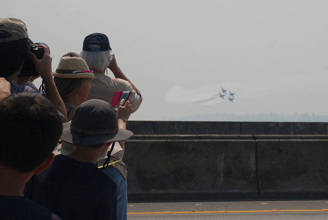 Seafair spectators watch and take photos of the Blue Angels air show practice while standing on the Interstate 90 bridge between Mercer Island and Seattle on Aug. 4. Katie Metzger/staff photo