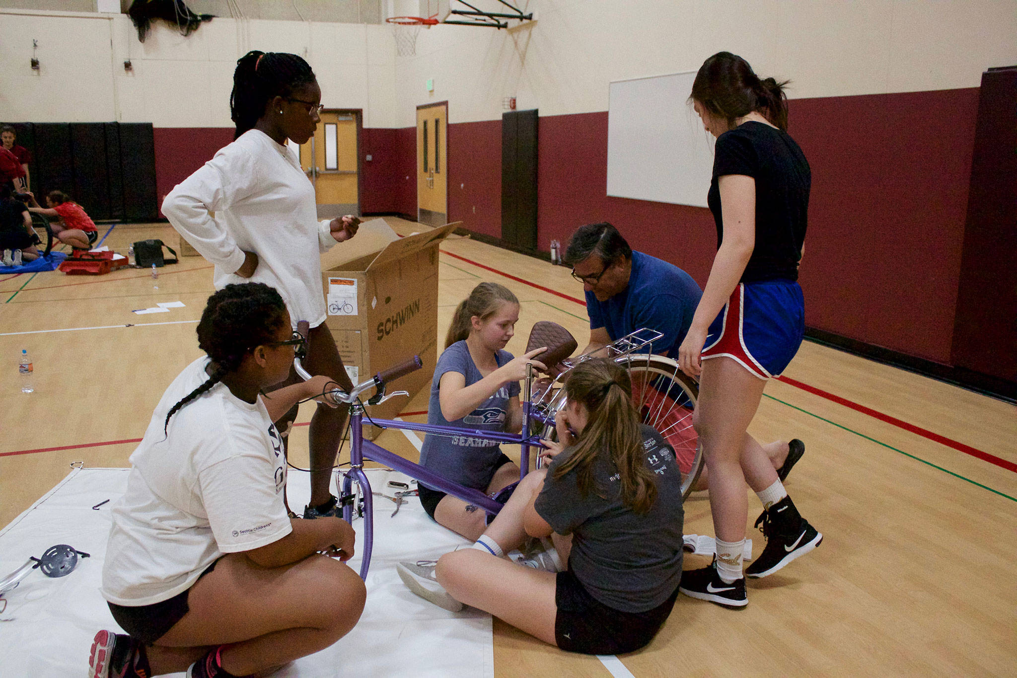 MIHS girls’ volleyball team bonds by building bikes