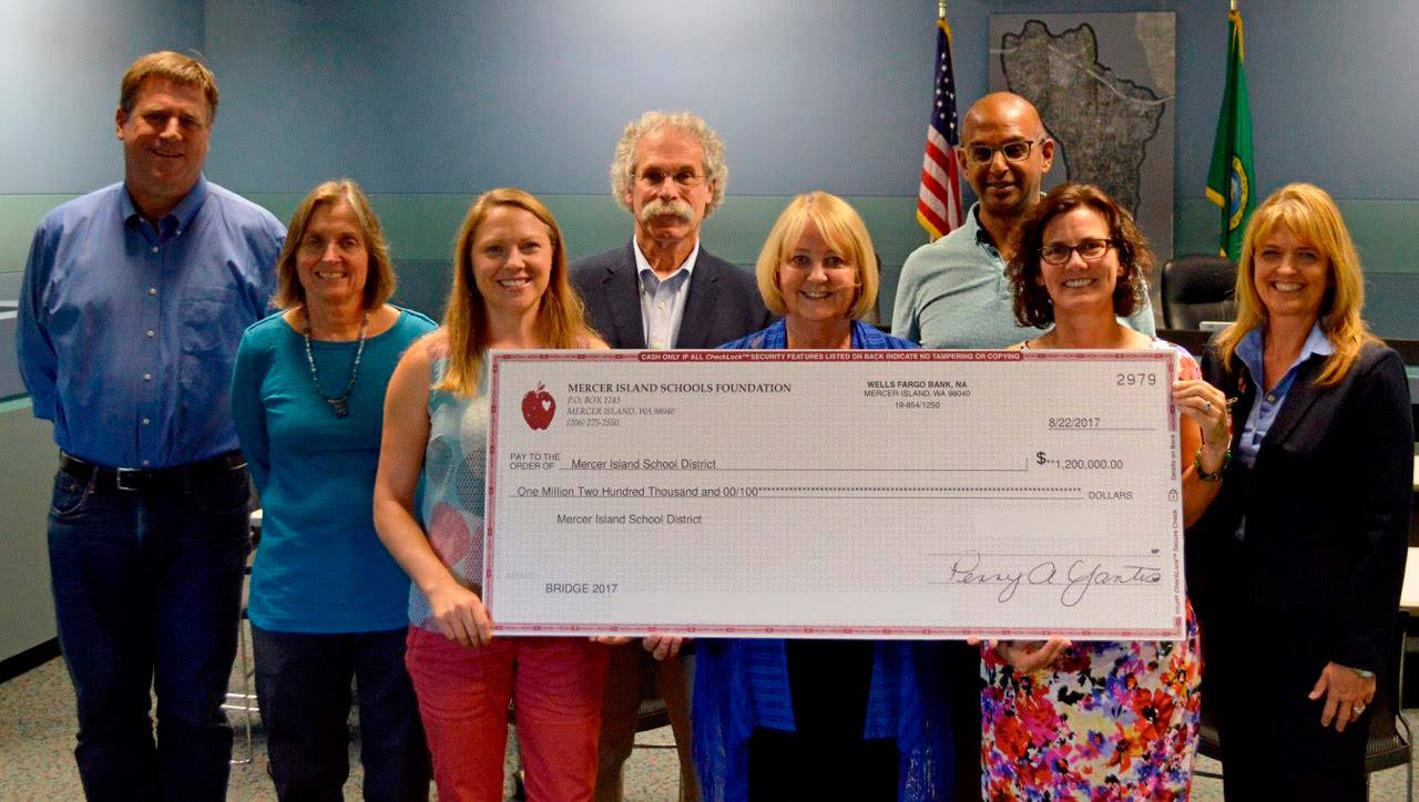 The School Board received a $1.2 million check from the Mercer Island Schools Foundation following its successful BRIDGE campaign. Photo courtesy of Craig Degginger/Mercer Island School District