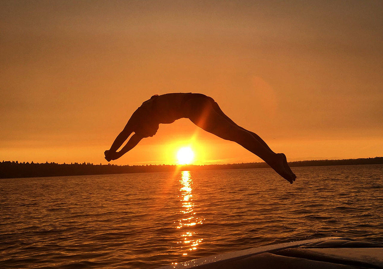Islander Brooke Andrews dives into Lake Washington. Photo courtesy of Dawn Bova