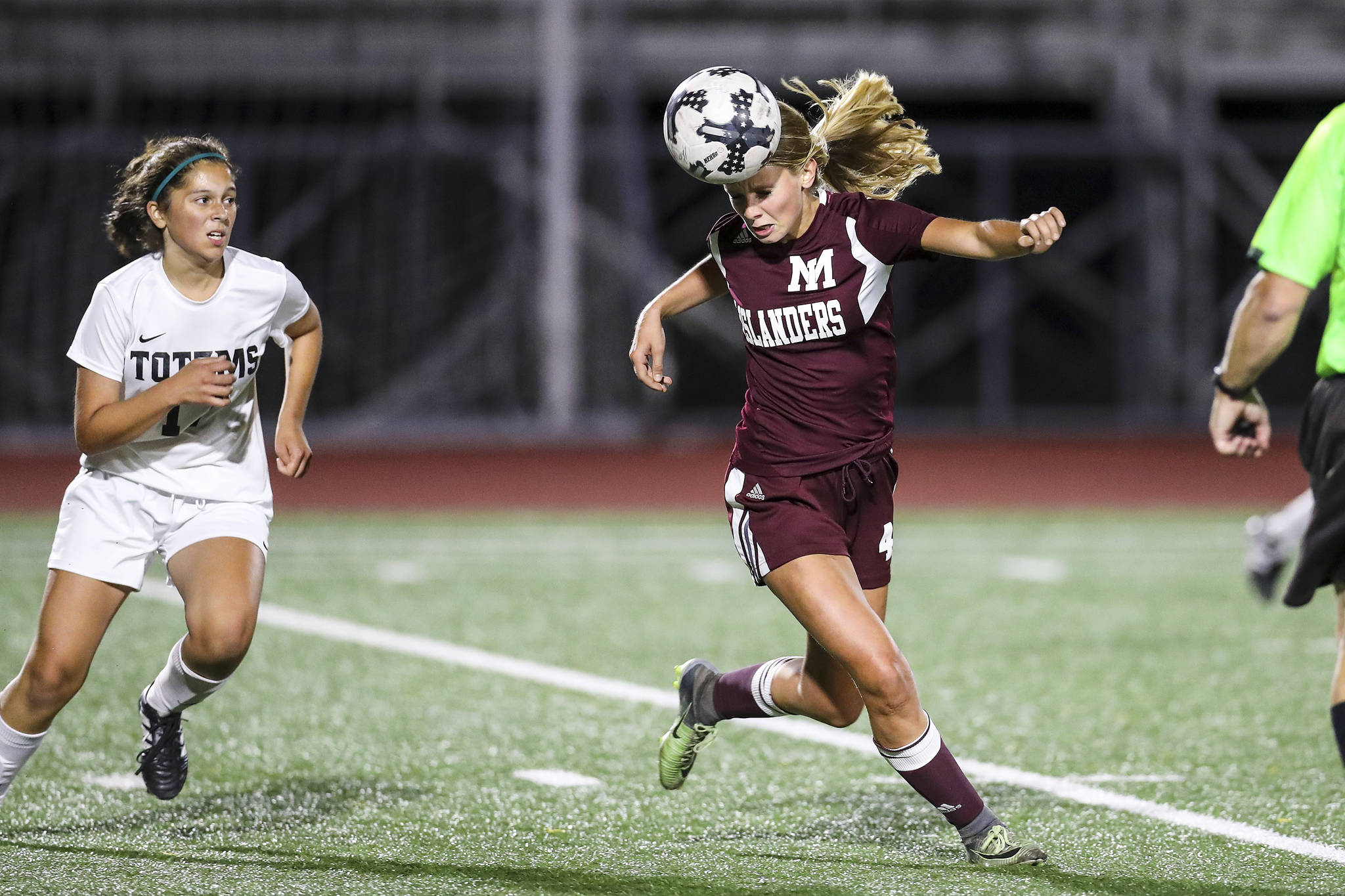 Photo courtesy of Rick Edelman/Rick Edelman Photography                                Mercer Island midfielder Jackie Stenberg, right, passes the ball to one of her teammates via a header against the Sammamish Totems on Sept. 14 in Bellevue.