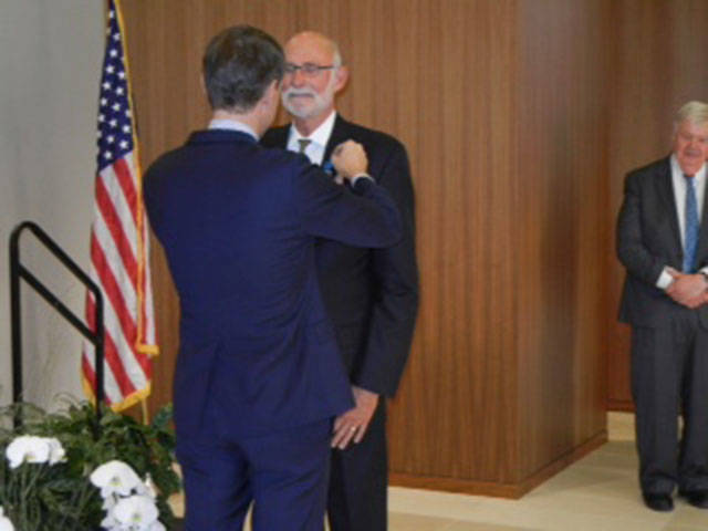 Alan Merkle receives the Chevalier de l’Ordre National du Merite on Sept. 15. Photo courtesy of Rich Conrad