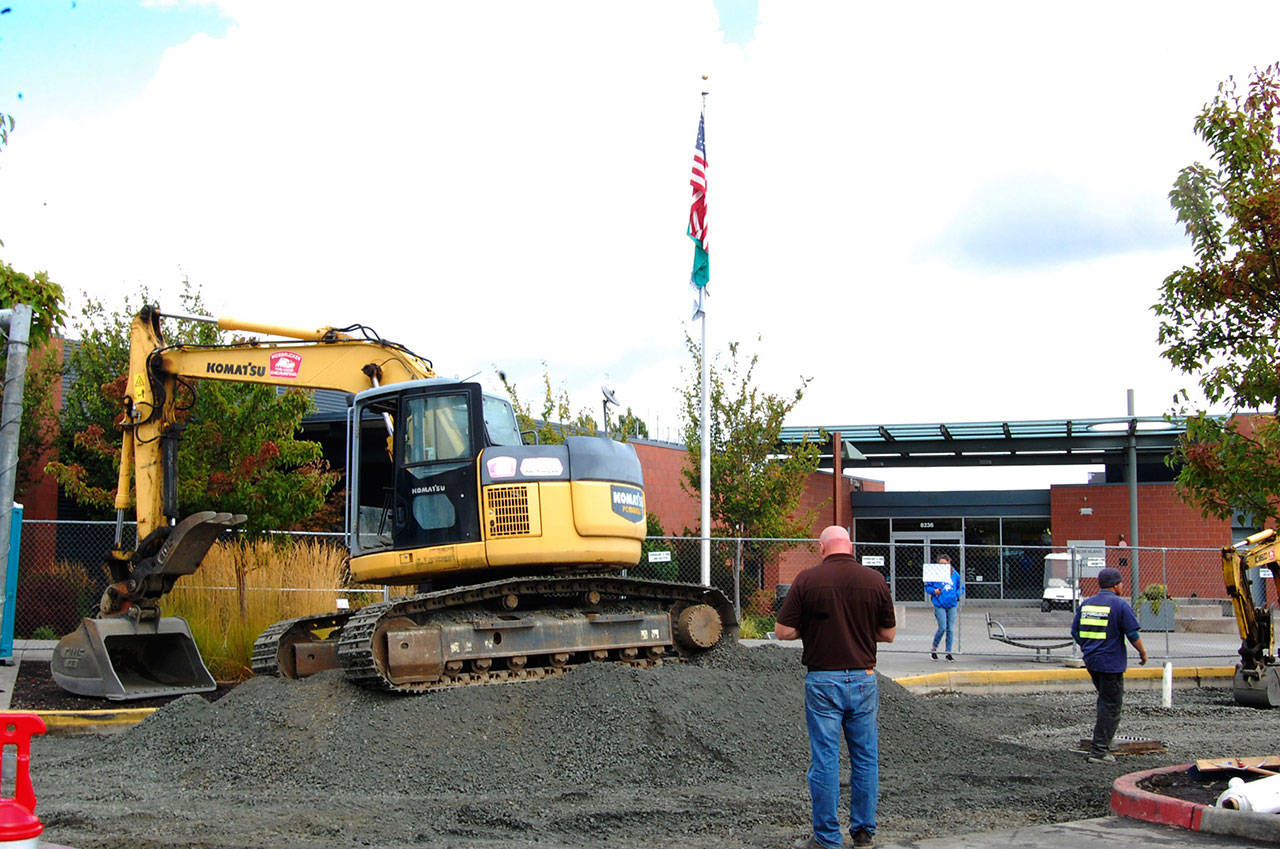 Construction crews do some excavation work to correct drainage issues in front of the main entrance to the Community and Event Center on Sept. 21. Katie Metzger/staff photos