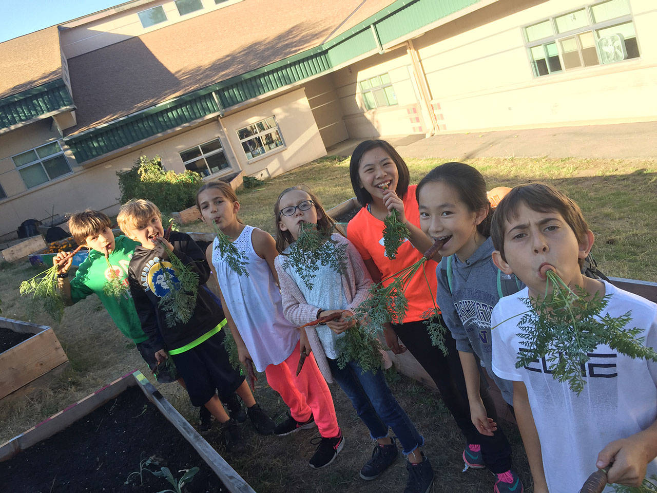 Lakeridge elementary students goof around in the community garden. Photo courtesy of Nancy Weil