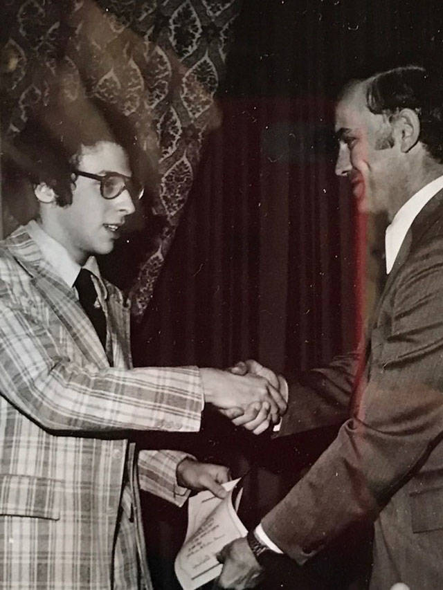 MIHS student Bill Hochberg, a member of the Committee to Save the Earth, accepts the 1976 Washington State Environmental Excellence Award from then Governor Dan Evans. Courtesy photo