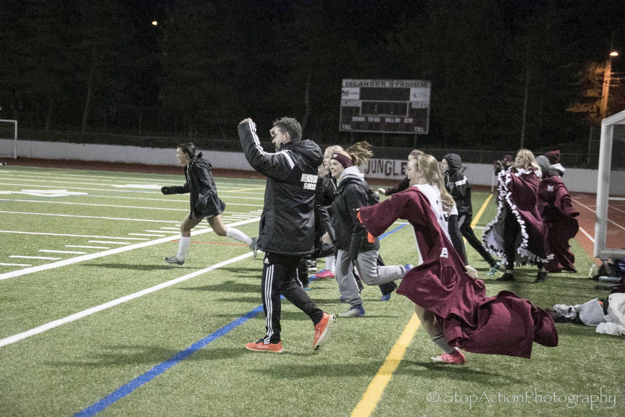 Photo courtesy of Don Borin/Stop Action Photography                                Mercer Island Islanders girls soccer head coach James Valles, center, and a multitude of Islanders players celebrate after the final whistle signaling the end of the game. Mercer Island defeated the Bethel Braves 3-2 in the first round of the Class 3A state playoffs on Nov. 7 at Mercer Island High School.