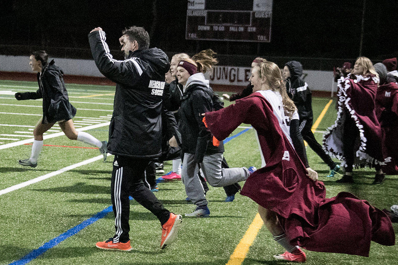 Photo courtesy of Don Borin/Stop Action Photography                                Mercer Island Islanders girls soccer head coach James Valles, center, and a multitude of Islanders players celebrate after the final whistle signaling the end of the game. Mercer Island defeated the Bethel Braves 3-2 in the first round of the Class 3A state playoffs on Nov. 7 at Mercer Island High School.