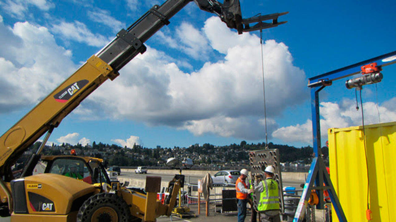 Crews lower steel anchor caps into the floating bridge pontoons. Each anchor cap weighs 3,500 pounds. Photo courtesy of Sound Transit