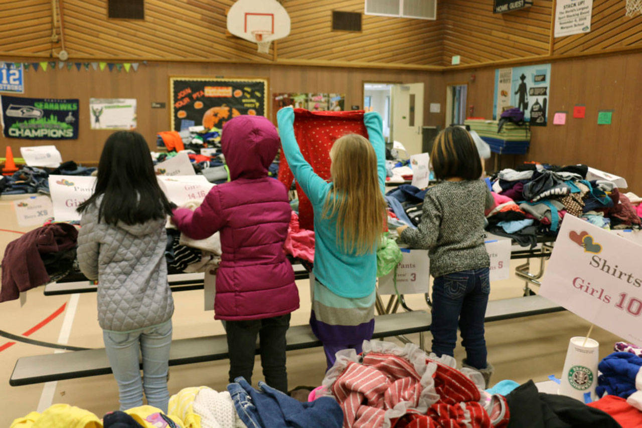During parent conferences last week, volunteers set up a dozen tables loaded with donated clothes in the gym of Evergreen Heights Elementary in Auburn. Families were invited to browse the selection and take what they need. Photo courtesy of the Auburn School District