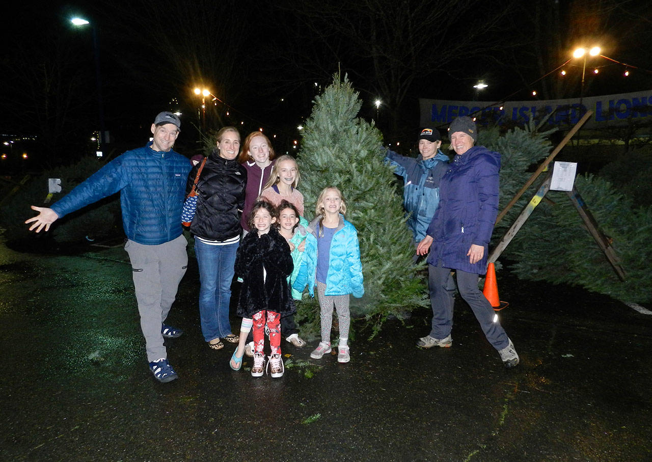 The Whelan family (parents Scott and Shelley with their children Austin, Lindsay and Reagan and friends Charlotte and Mia Weil) poses after buying their holiday tree at the Mercer Island Youth and Family Services Foundation and Lions Club tree lot. The lot opened Saturday and will sell trees Thursday through Sunday until Dec. 22. Photo courtesy of Cindy Goodwin