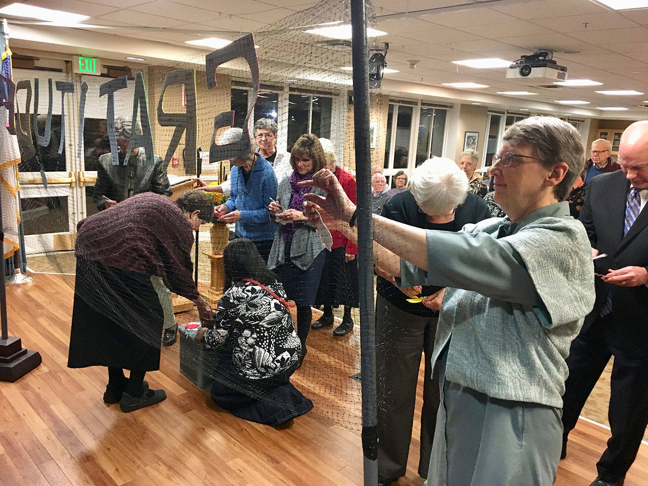 Event attendees hang things on the “the wall of gratitude” after a community interfaith Thanksgiving service at Covenant Shores on Nov. 19. Photo courtesy of Greg Asimakoupoulos
