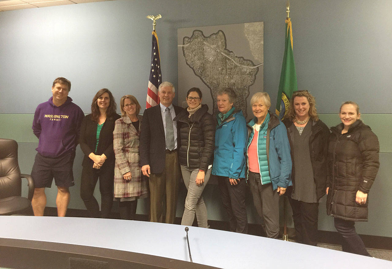 Newly sworn in Mercer Island City Council member Tom Acker poses with family, friends and supporters on Nov. 28. Photo courtesy of Traci Granbois