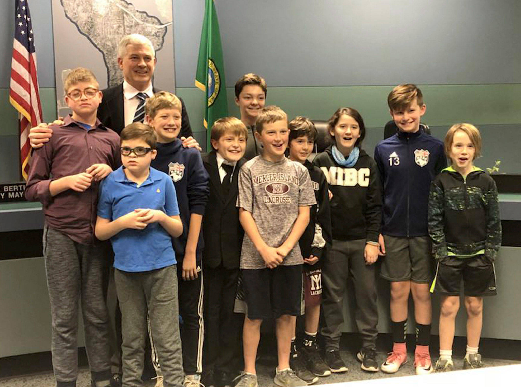Tom Acker poses with his three sons and other Mercer Island kids after being ceremoniously sworn in to the City Council on Dec. 5. Photo courtesy of Julie Underwood