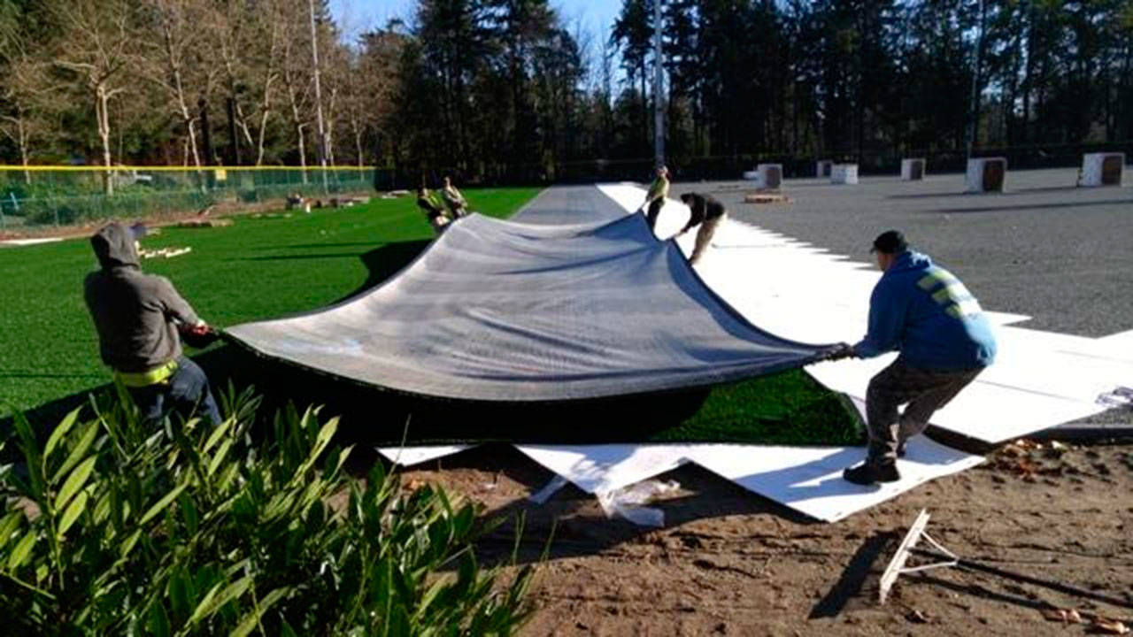 Crews stretch out rolls of all-weather turf for the Island Crest Park sportsfield improvement project. Photo courtesy of the city of Mercer Island