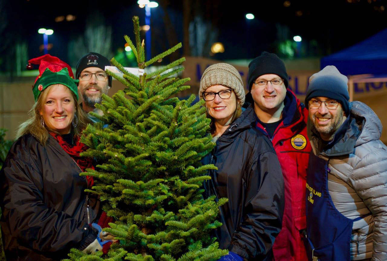 Liana Montague, Tom Montague, Noelle Davenport, Jon Conradt and Ken Urman volunteer at the Mercer Island tree lot, organized this year by Mercer Island Youth and Family Services (MIYFS) and the Lions Club. Conradt and Urman are MIYFS Foundation Board members, and Liana Montague is the MIYFS Mental Health Counselor at Island Park Elementary. Photo courtesy of MIYFS