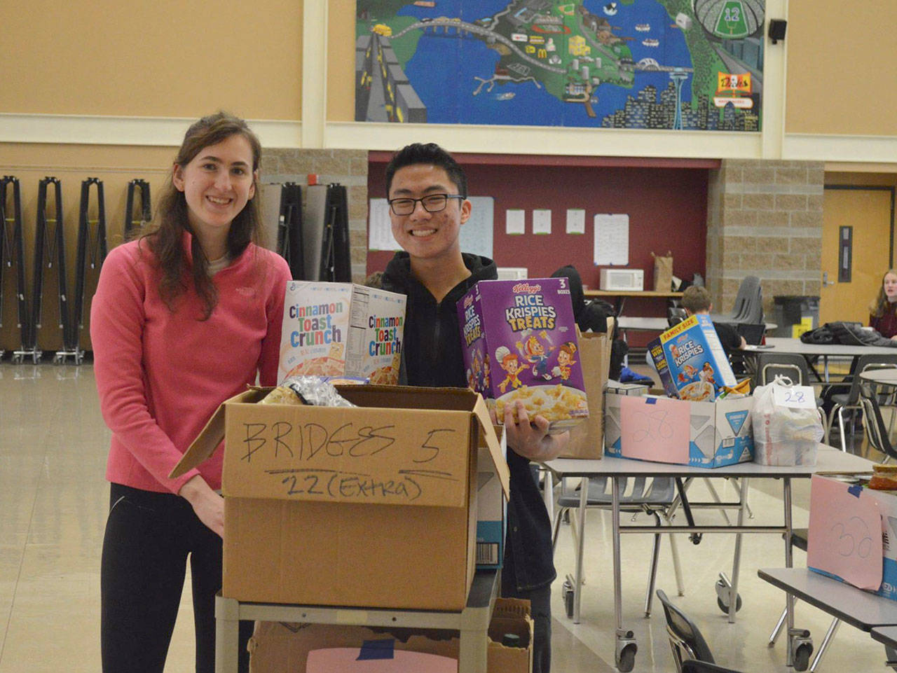 Mercer Island High School collected items to benefit 35 families identified through the Mercer Island Youth and Family Services Foundation. Students were busy on Dec. 6, moving the food into the commons. Photo courtesy of the Mercer Island School District