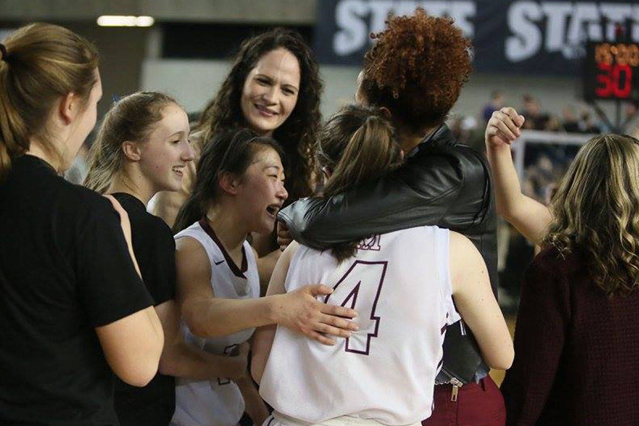 Photo courtesy of Don Borin/Stop Action Photography                                The Mercer Island Islanders basketball team celebrates after defeating the Bishop Blanchet Braves 52-47 in the Class 3A girls state championship game on March 4 at the Tacoma Dome.