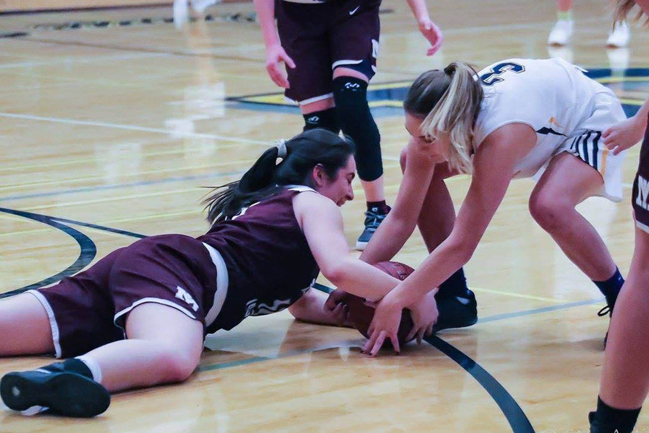 Photo courtesy of Don Borin/Stop Action Photography                                Mercer Island Islanders junior guard Angelina Barokas, left, dives for a loose ball against the Bellevue Wolverines on Jan. 3. Bellevue defeated Mercer Island 53-19 in a matchup between rivals.