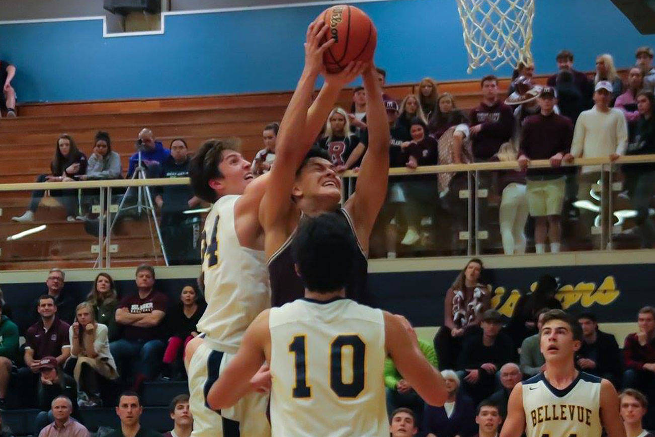 Photo courtesy of Don Borin/Stop Action Photography                                Mercer Island senior forward Giovanni Cervantes-Rocha, center, secures a rebound against the Bellevue Wolverines on Jan. 3. Bellevue defeated Mercer Island 61-57 in a matchup between rivals.