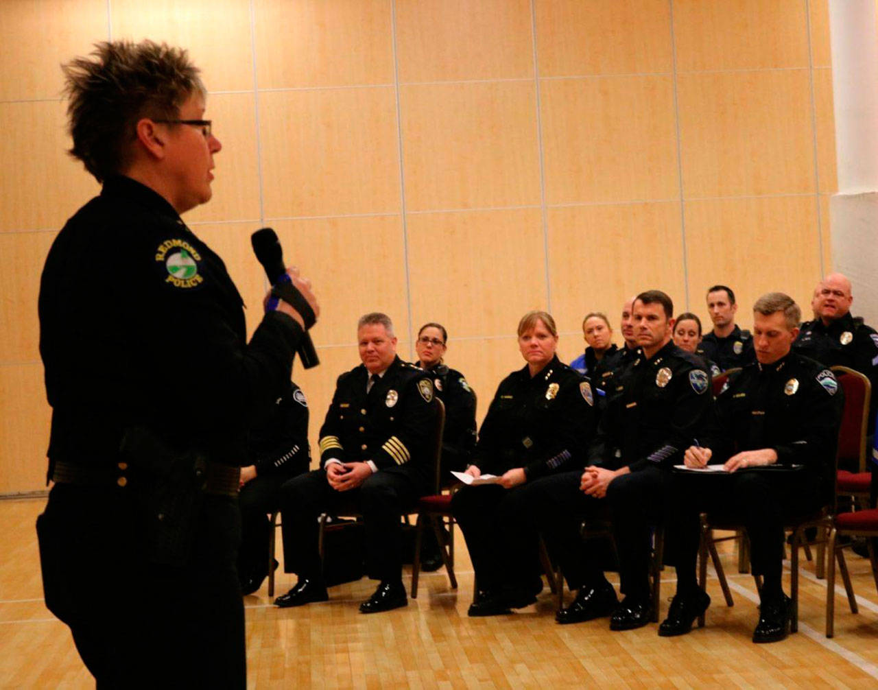 Redmond Police Department Chief Kristi Wilson, left, addresses the crowd — which features five other Eastside police chiefs in the foreground — during an Eastside Muslim Safety Forum at the Muslim Association of Puget Sound in Redmond last January. File photo