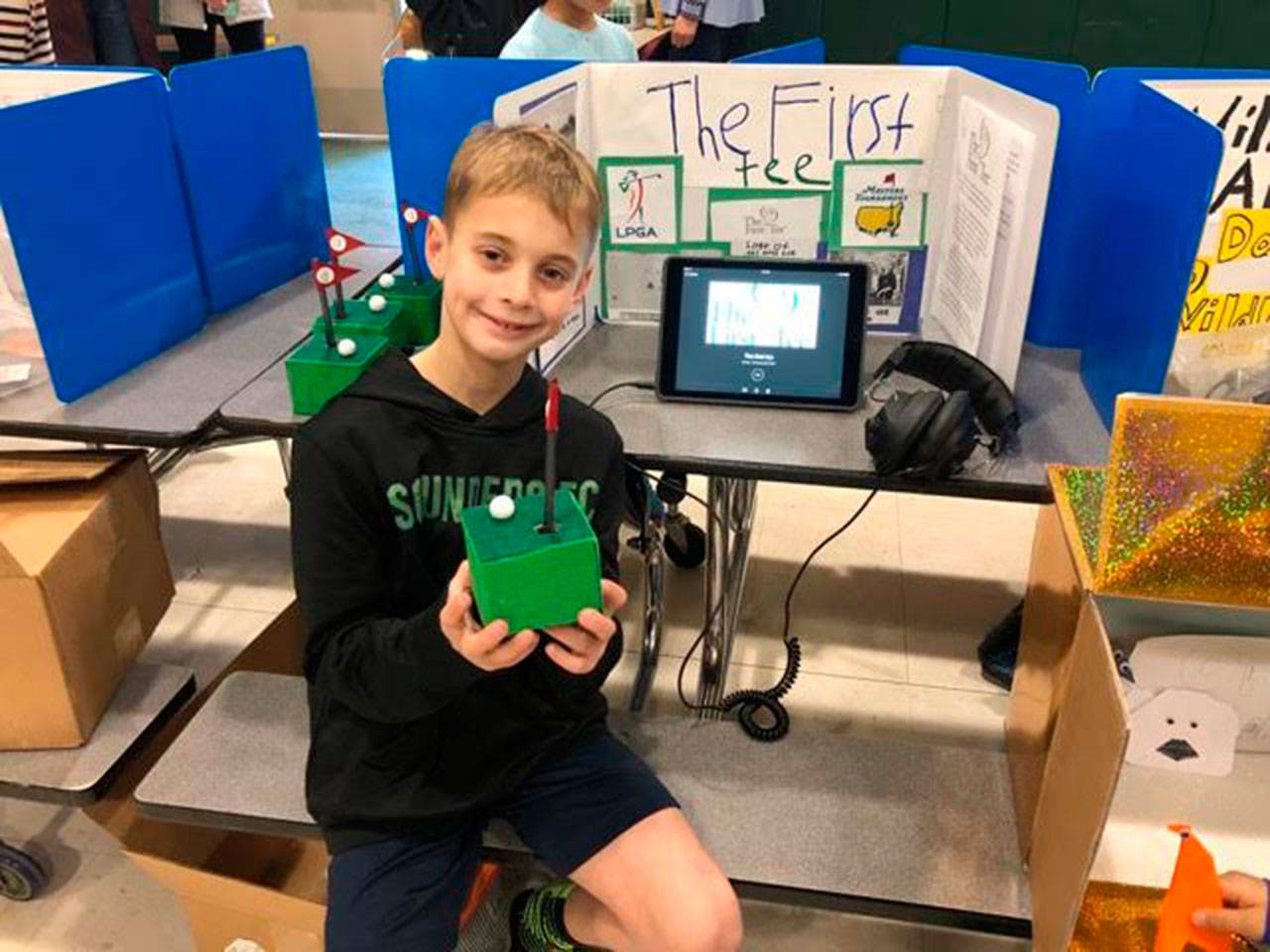 A Lakeridge Elementary student holds up his project for the Merchants with a Cause Fair. Photo courtesy of Craig Degginger/Mercer Island School District