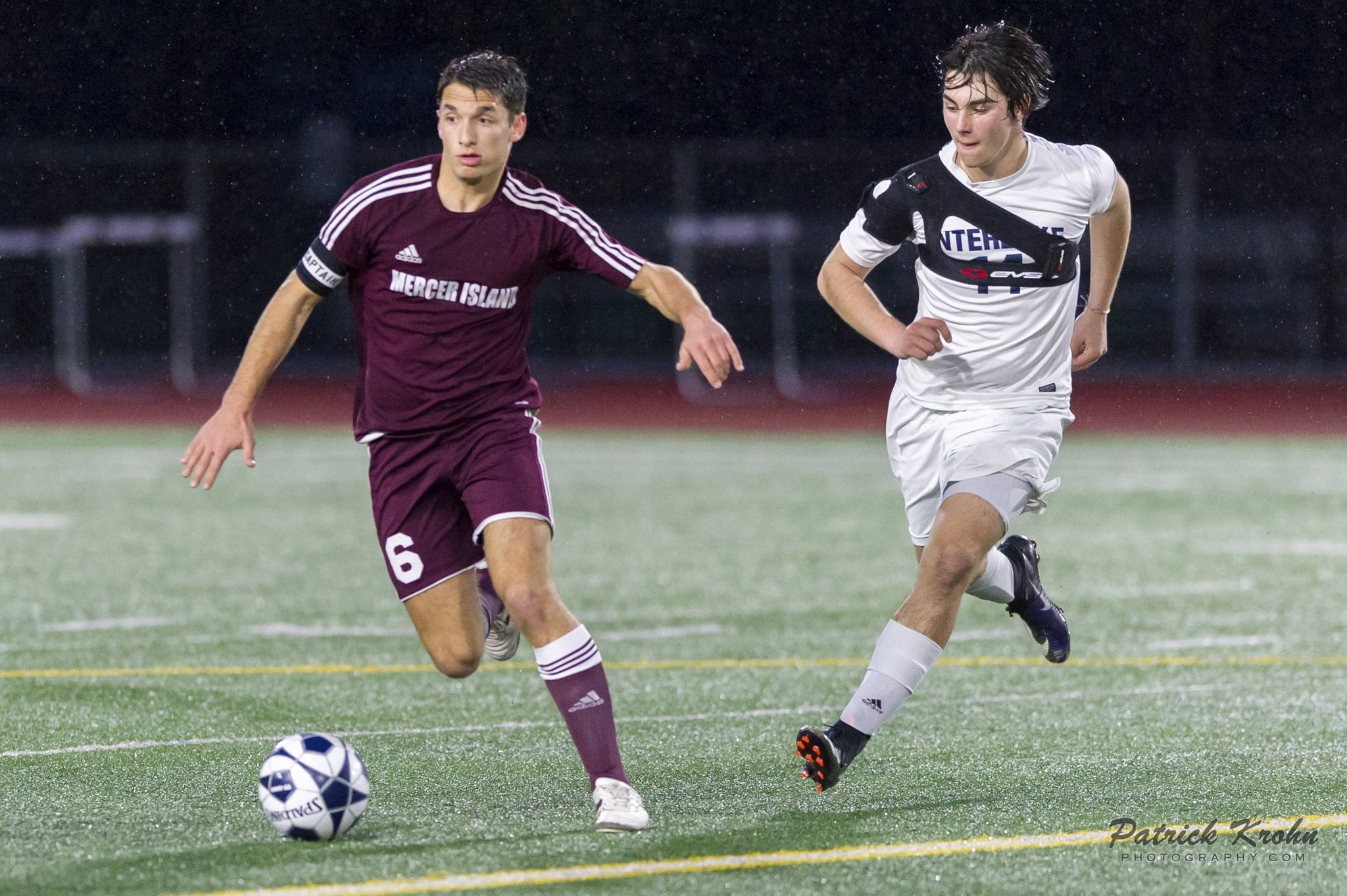 Photo courtesy of Patrick Krohn/Patrick Krohn Photography                                Mercer Island Islanders defender Reis Kissel, left, dribbles the ball upfield while being guarded by Interlake Saints midfielder Andre Garone, right, in a matchup between KingCo 3A teams on April 11 at Interlake High School in Bellevue. Mercer Island defeated Interlake 2-1 in the contest.