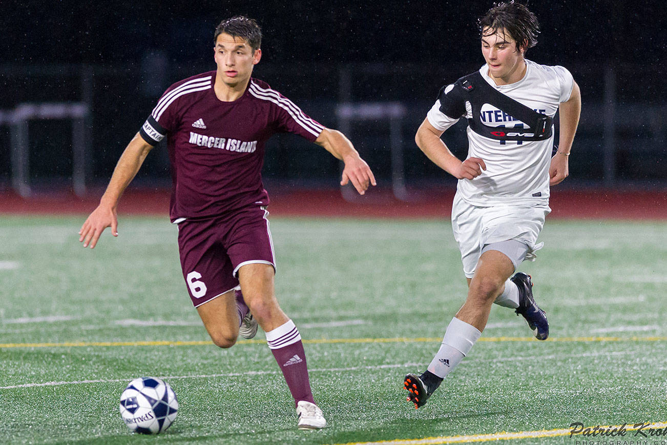 Photo courtesy of Patrick Krohn/Patrick Krohn Photography                                Mercer Island Islanders defender Reis Kissel, left, dribbles the ball upfield while being guarded by Interlake Saints midfielder Andre Garone, right, in a matchup between KingCo 3A teams on April 11 at Interlake High School in Bellevue. Mercer Island defeated Interlake 2-1 in the contest.
