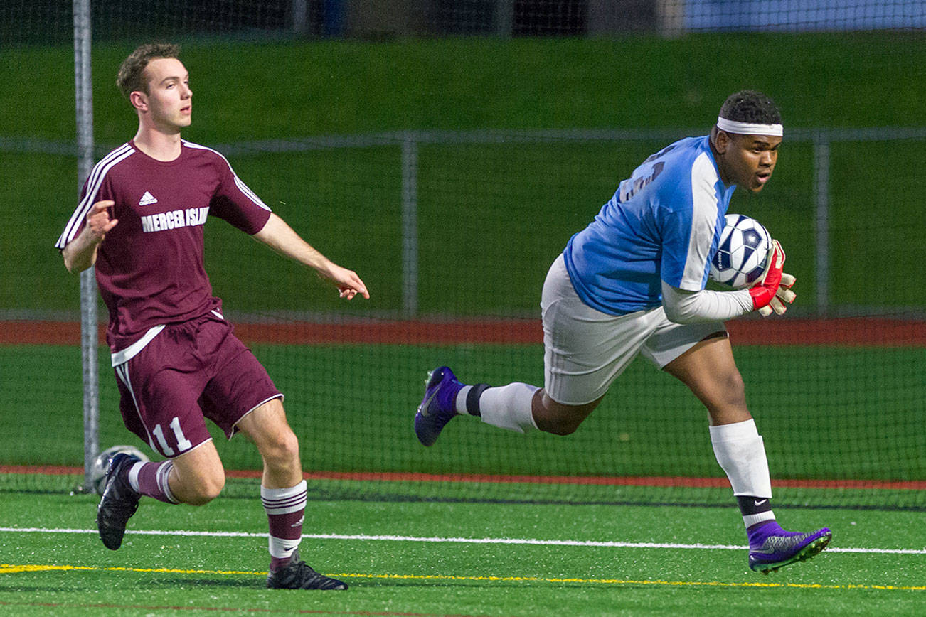 Mercer Island Islanders boys soccer player Emil Talerman, left, pursues a through ball before Interlake goalie gains possession of the ball in a game featuring rivals on April 11 at Interlake High School. Mercer Island has won eight of their past nine games. (Photo courtesy of Patrick Krohn/Patrick Krohn Photography)