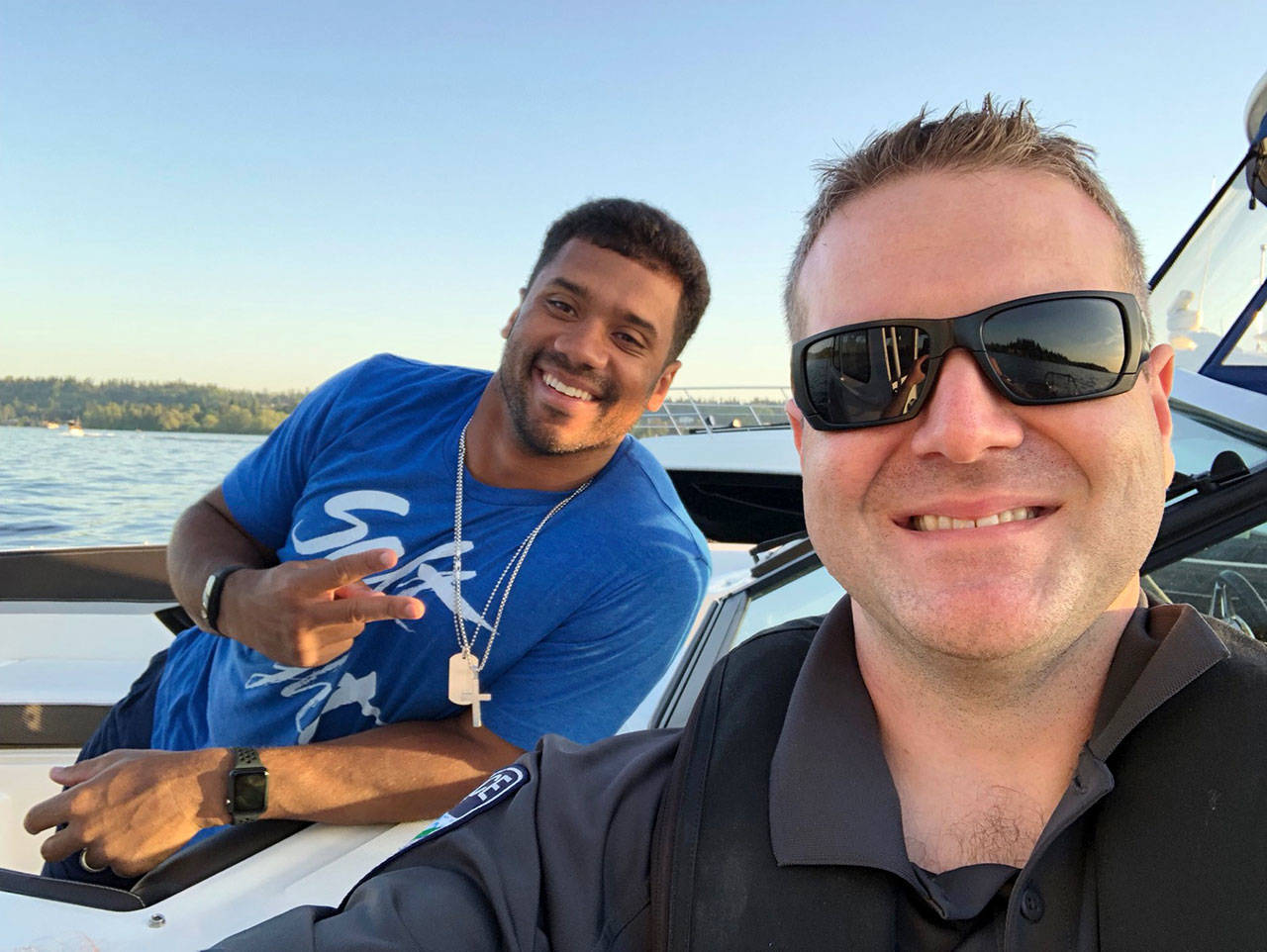The Mercer Island Police Department posted a selfie with Russell Wilson on its Facebook page, writing that the officers “provided an assist for the big win” after helping the Seahawks quarterback with mechanical issues with his boat. Photo via Facebook