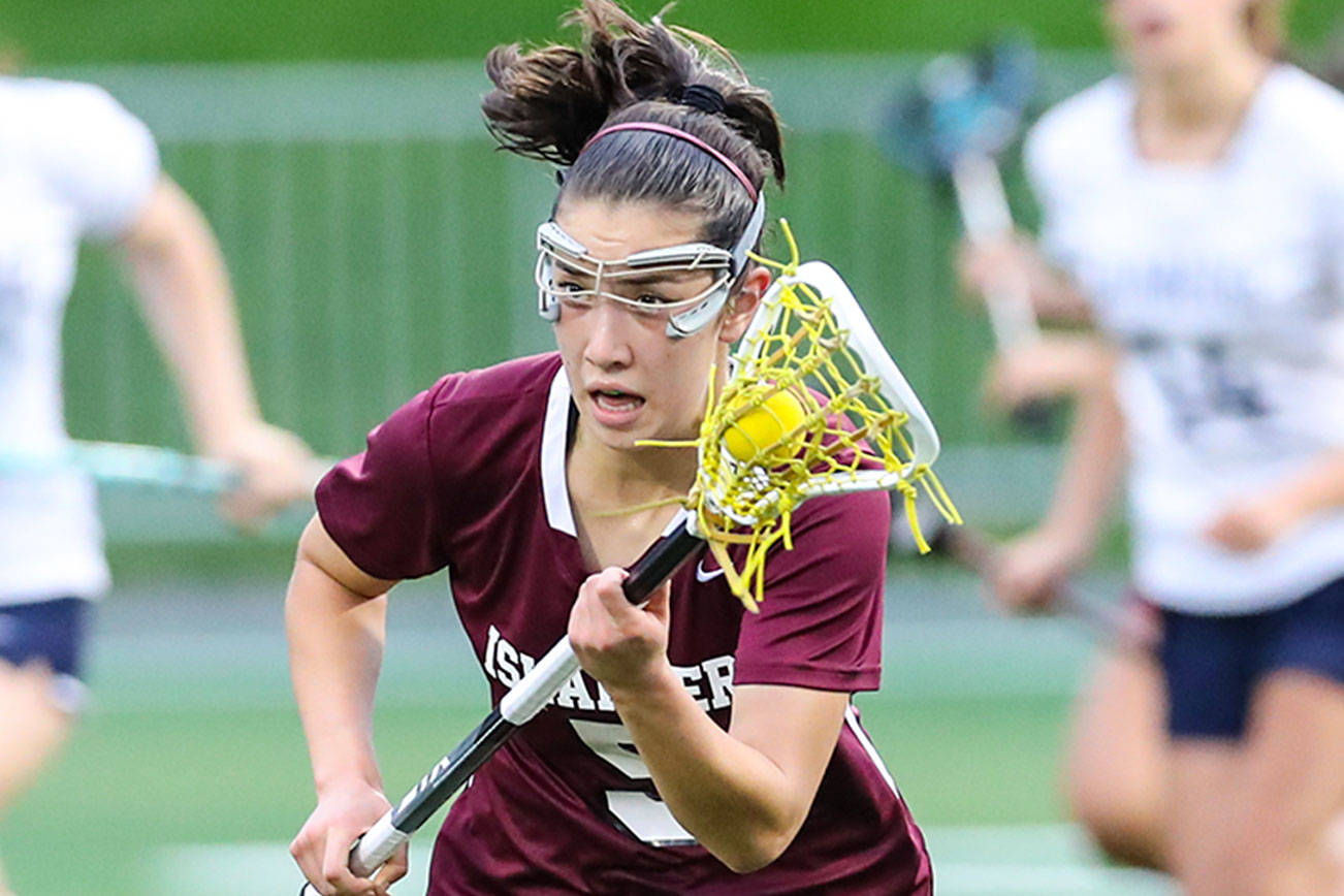 Photo courtesy of Rick Edelman/Rick Edelman Photography                                Mercer Island player Grace Fujinaga, who scored three goals in the state title game, carried the ball upfield while being chased by Bainbridge Island player Maggie Sweeney (left).